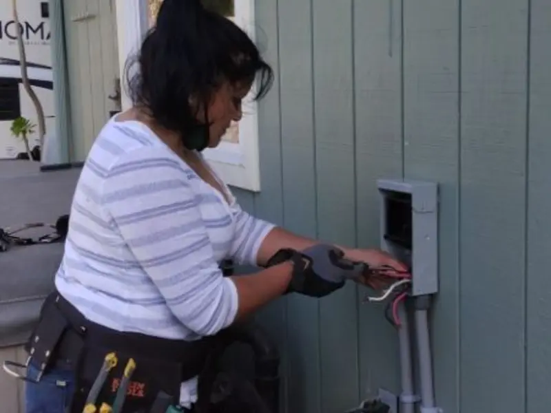 Licensed electrician wiring an exterior subpanel in Casselberry